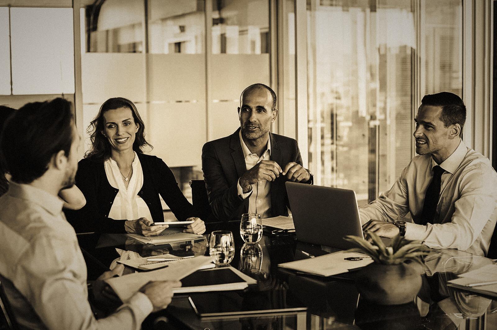 Executives in conversation around a conference table